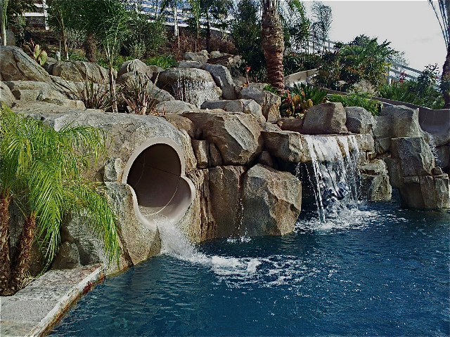 Waterslide made from artificial rocks by West Coast Rockscapes, providing thrilling outdoor entertainment and adventure for all ages